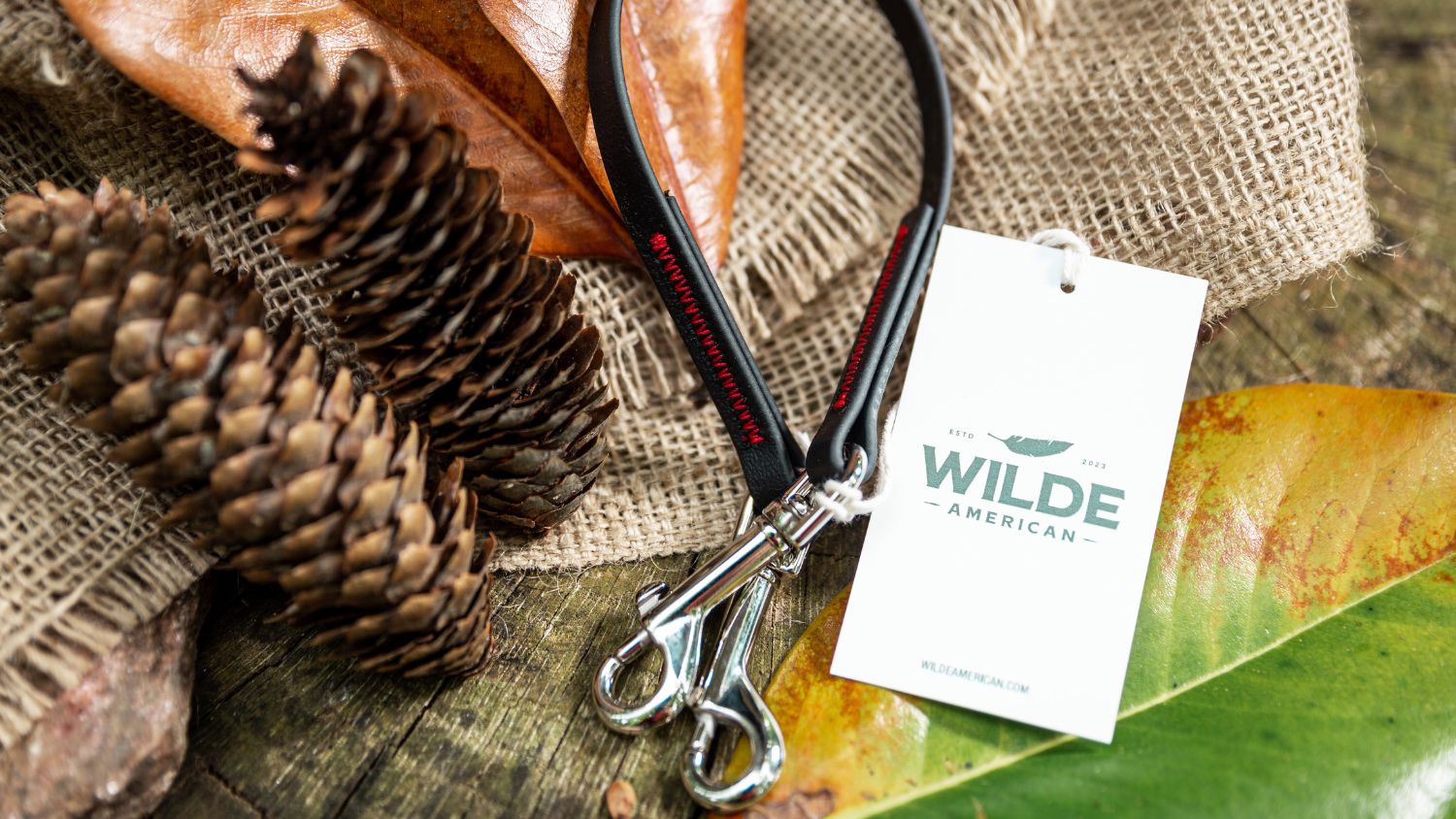Wilde American Dog Leash flat lay on burlap and surrounded by leaves and pinecones