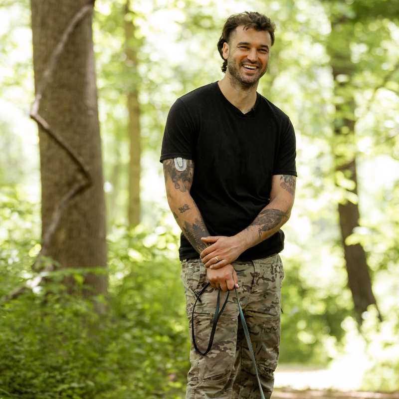 Wilde American Owner Carter Wilde smiling in the woods