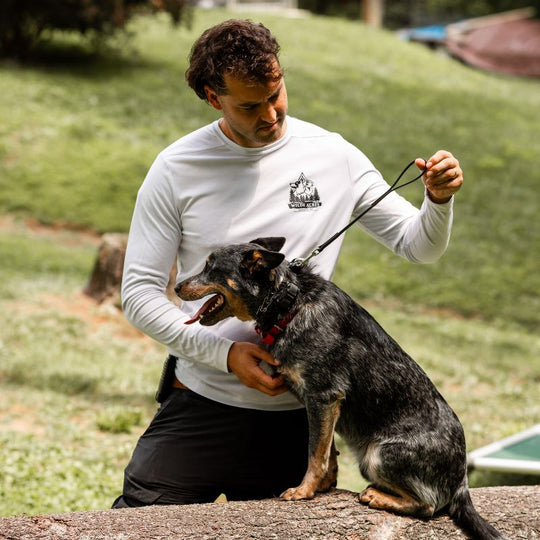 Dog Trainer plays with dog on Wilde American Micro Leash outside